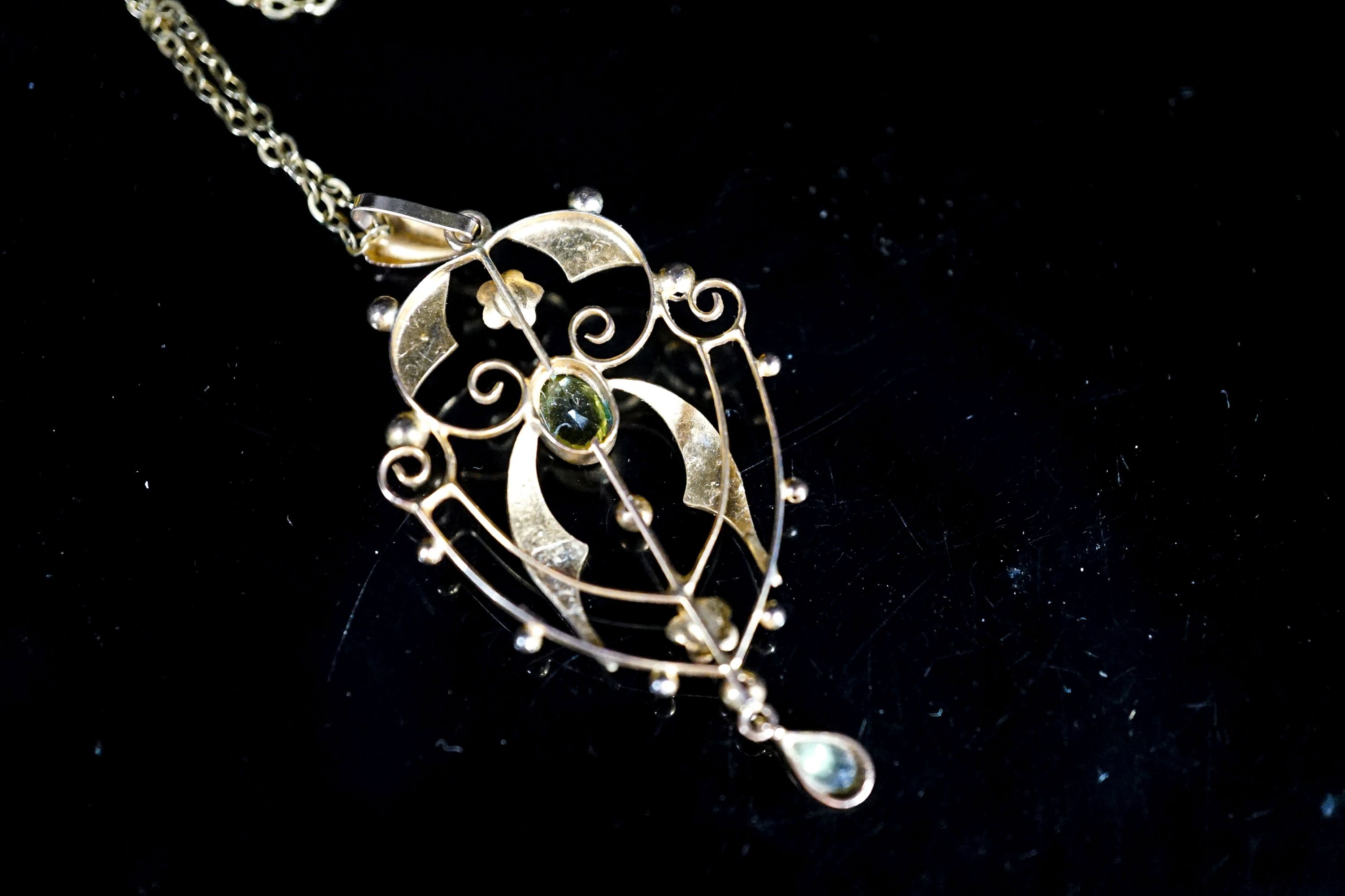 An Edwardian 9ct, peridot and seed pearl set drop pendant, 42mm, on a 9ct chain, 49cm